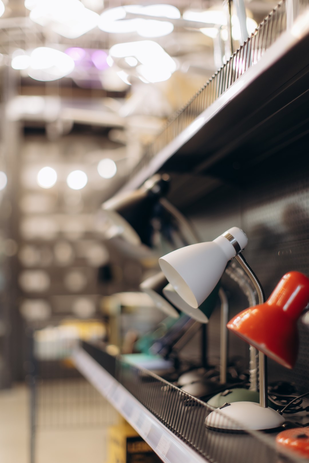 Modern Desk Lamps Displayed on Shelves in Hardware Store